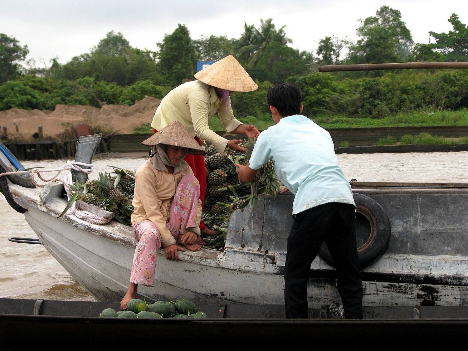 Trading boats loaded with fruit at a Mekong Delta floating market